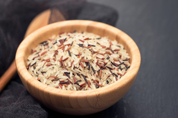 mix of white, brown and black rice in bowl
