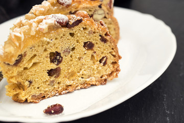 fruit cake with nuts on white dish