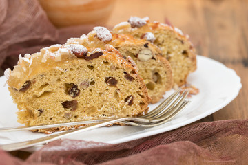 fruit cake with nuts on white dish