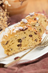 fruit cake with nuts on white dish