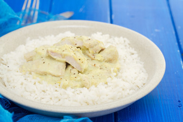 turkey curry with boiled rice on plate