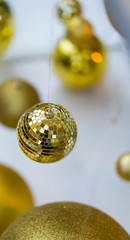 Hanging shiny golden ball and lighting Christmas wreath