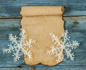 Christmas greeting card and snowflakes, wooden background