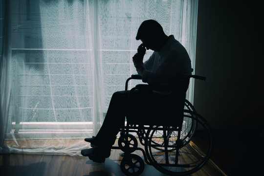 Silhouette of handicapped Man sitting on wheelchair in front of a large  panoramic window in hospital,He is sad and lonely. Stock Photo | Adobe Stock