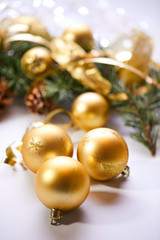Christmas tree branch with gold balls and ribbons