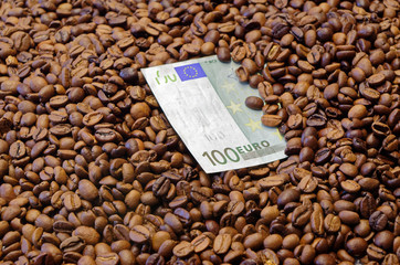 100 Euro banknote in the roasted coffee beans