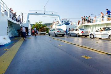 Cars, people and truck are exit from ferryboat, unloading