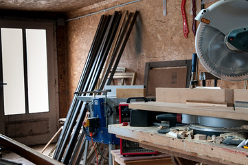 Circular chop  saw for cutting picture frames in focus in a small workshop.