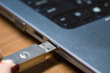 Inserting a usb drive into a laptop computer, close up