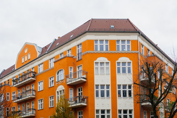 Fototapeta na wymiar orange corner building with grey sky