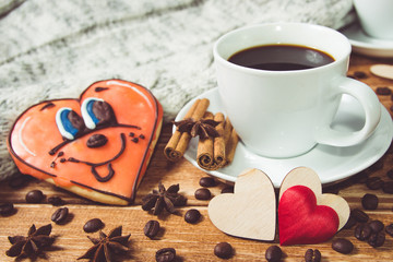 Valentine's day concept . Cup of coffee and two heart on wooden background with food decor.