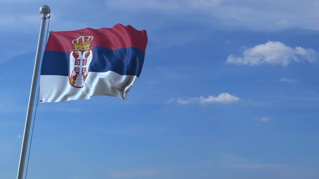 Airplane flying over waving flag of Serbia