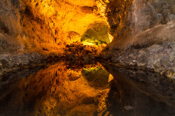 A beautiful reflection inside a cave. warm cave colours reflected inside a pool of water.