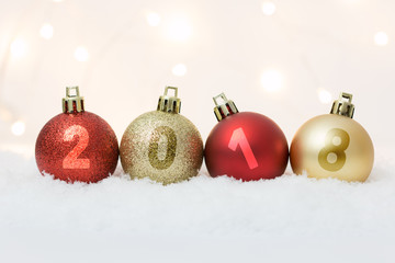 Happy New Year 2018 celebration with ball decoration on snow light bokeh background