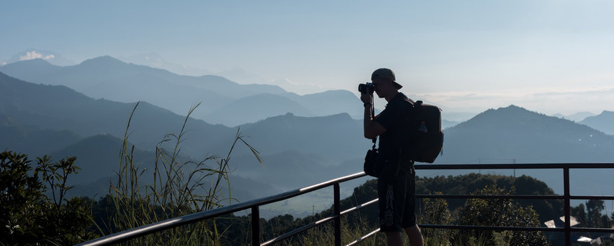 Silhouette of tourist make photo of scenic himalayas mountains, Pokhara, Nepal