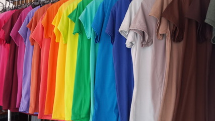 Colorful t-shirts on hangers
