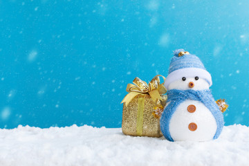 Merry christmas and Happy new year season with greeting card, illustration. Snowman and gift box on the snow in time with snowfall