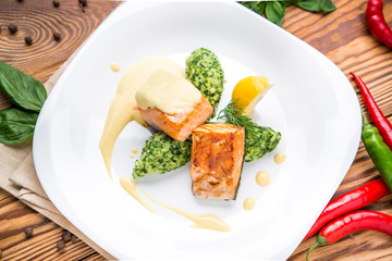 Salmon steak with mashed potatoes and greens