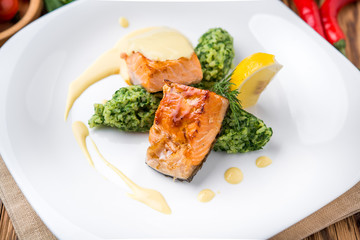 Salmon steak with mashed potatoes and greens