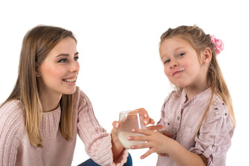 Mother milks to the daughter.The daughter with pleasure drinks milk.