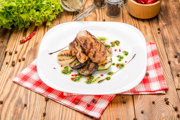 Beef steak with grilled vegetables and seasoning on serving board block