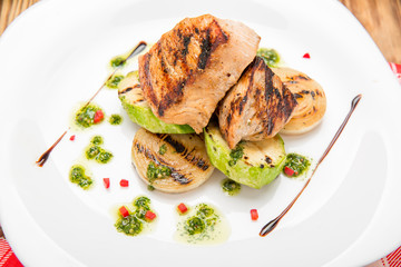 Beef steak with grilled vegetables and seasoning on serving board block