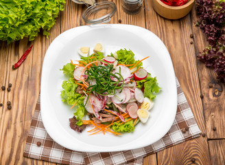 Spicy Beef Slices Meat Salad with Carrots, Tomatoes, Cucumber, Parsley, Radish and  leaves Spinach, rocket, red ruby chard on old wooden table