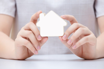 Obraz premium Woman holding the small home. Concept for real estate business.