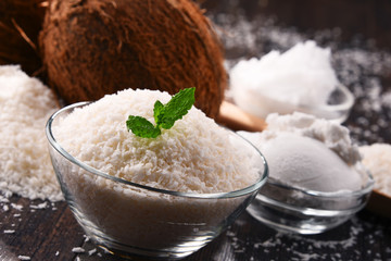 Composition with bowl of shredded coconut and shells