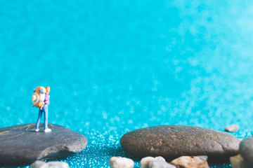 Miniature Backpacker , Tourist people on blue glitter background