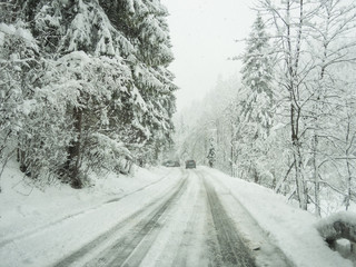 Austria. Driving shot, driver point-of-view. Footage driving on road during a snowfall