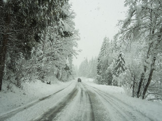 Austria. Driving shot, driver point-of-view. Footage driving on road during a snowfall