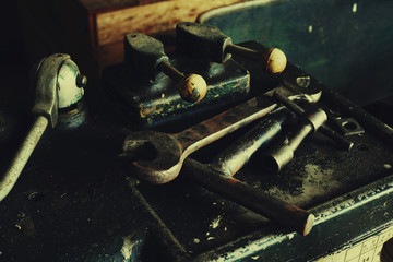 vintage metalwork or machinery tools with old and rusty lathe machine in vintage style and low key lighting