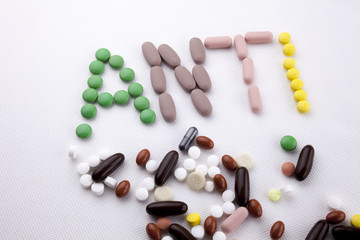 Hand writing text caption inspiration Medical care concept written with pills drugs capsule word ANTI forever young age feel anti aging On white isolated background with copy space