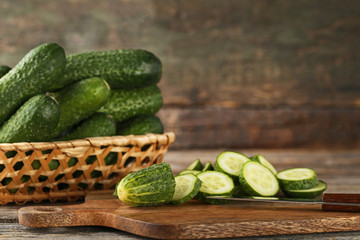 Fresh cucumbers on cutting board with knife