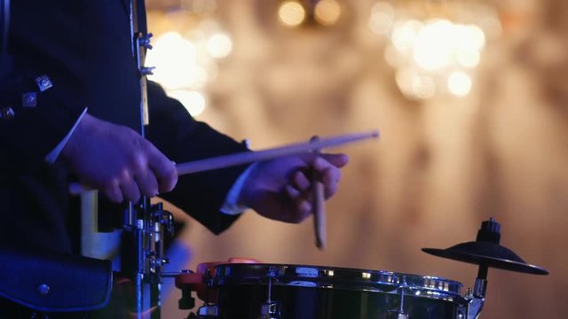 Drum performer plays drumstick at the stage