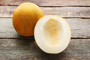 Sweet melons on grey wooden table
