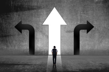 A businessman in doubt, having to choose between three different choices indicated by arrows...