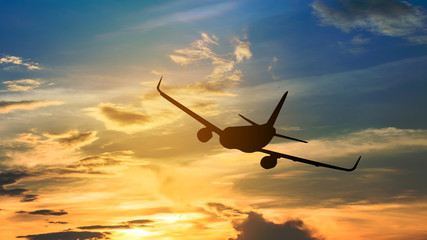 Silhouette from a landing plane that is flying to the airport.