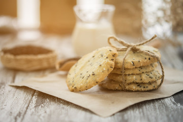 cookies with sesame seeds and glass of milk