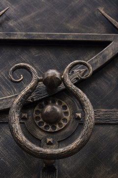 part of an ornament on a forged metal door with a ring
