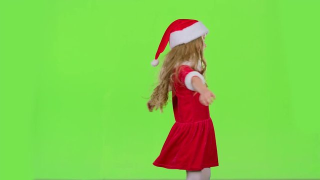 Child girl is spinning in her New Year's costume. Green screen. Slow motion