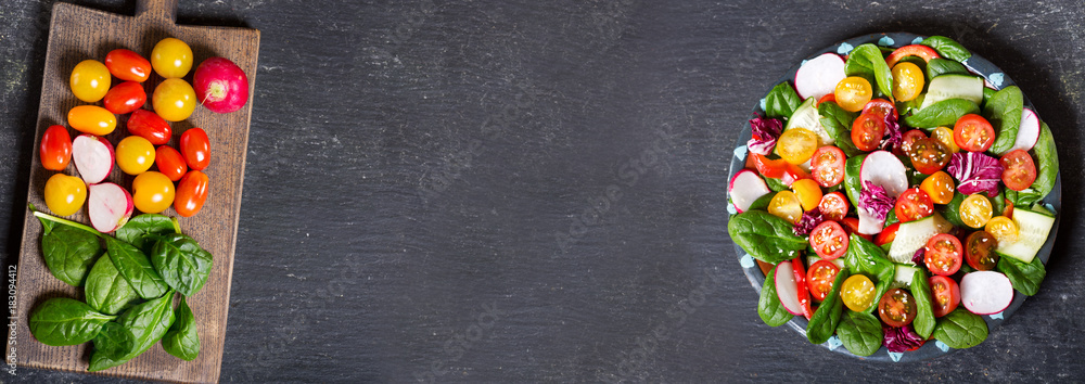 Wall mural plate of fresh salad on dark background