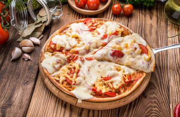 Italian pizza with cheese, on a wooden table