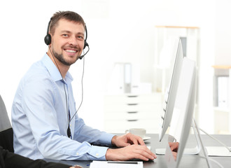 Male consulting manager with headset in office