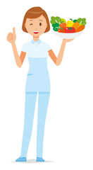 A female nurse wearing a white uniform has vegetables