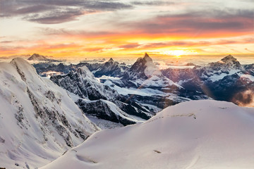 Sunset with mountains covered in snow