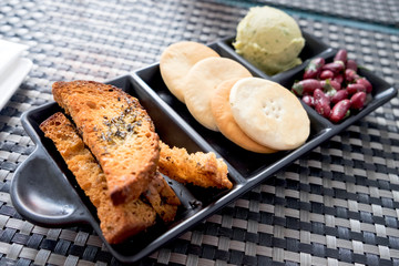 Maltese appetizer - beer snack with soft eggplant pate, pickled olives and salty crackers