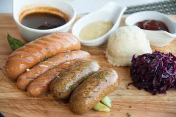  sausage barbecue in wood plate with sauce