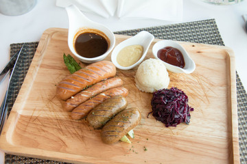  grill sausage barbecue in wood plate with sauce